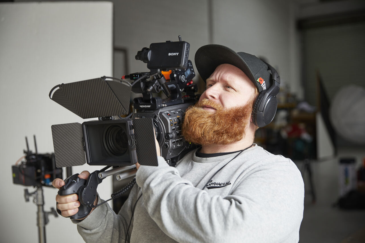 Jack operating a shoulder-mounted Sony cinema camera in a studio