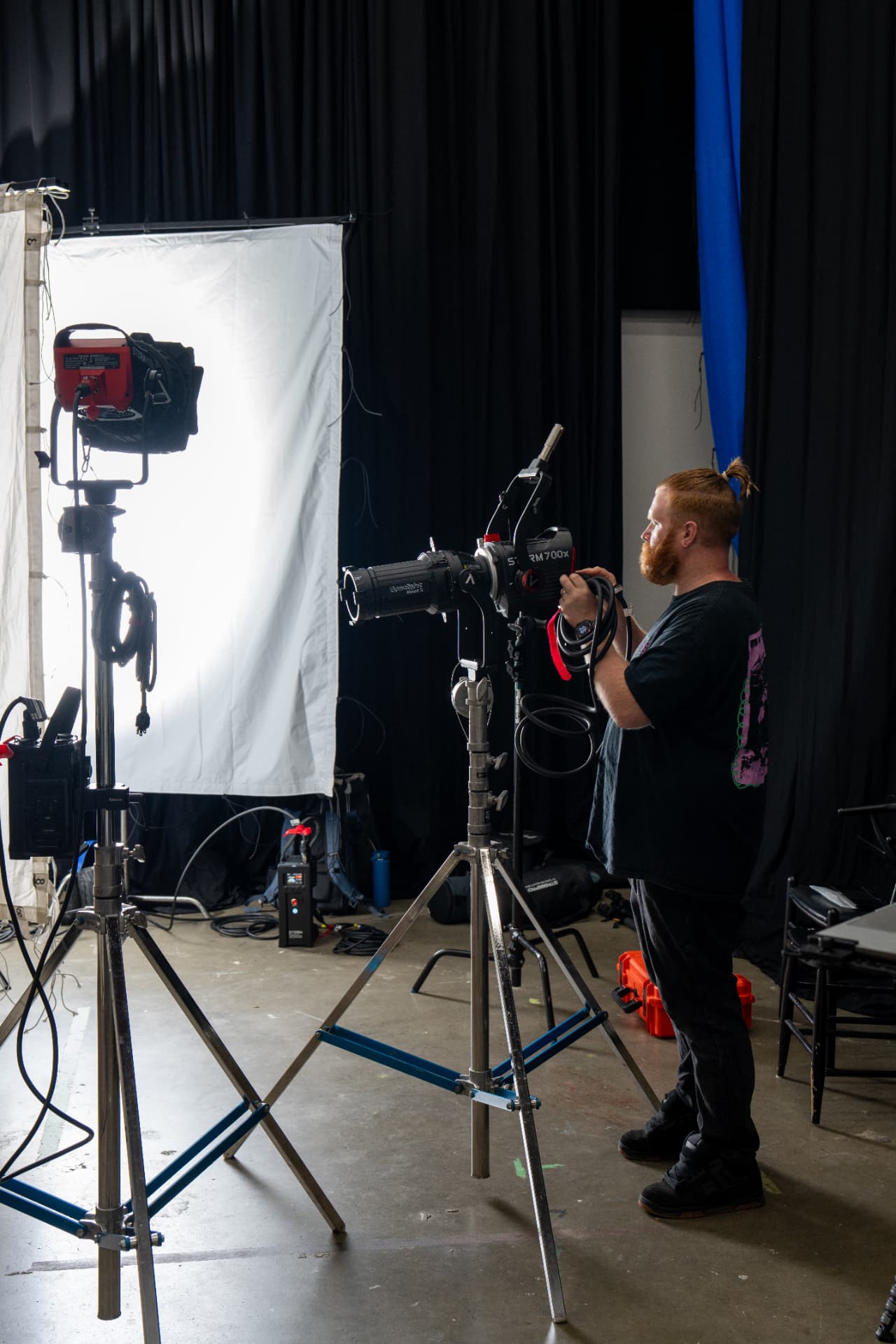 Jack setting up a spotlight on a studio lighting rig