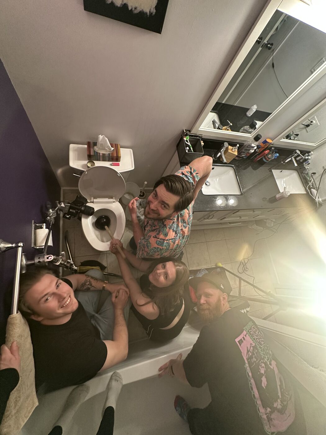 Overhead shot of a crew squeezed into a bathroom set